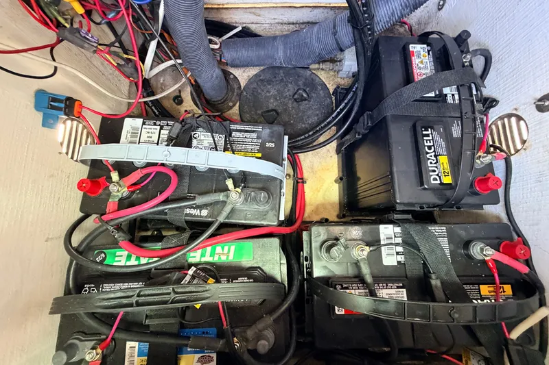 Slide: The Image of Battery compartment of a 2013 Pathfinder 2300 HPS boat with multiple batteries and wiring. - 64
