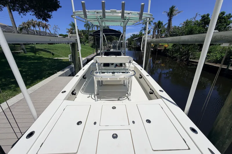 Slide: The Image of 2015 Pathfinder 2300 HPS boat docked by a scenic canal with lush greenery. - 34