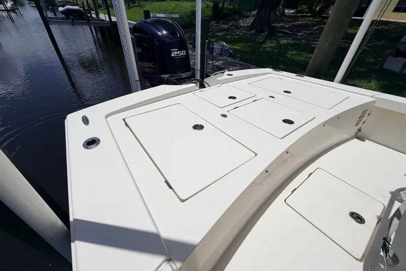 Slide: The Image of 2015 Pathfinder 2300 HPS boat with Yamaha 250 engine, docked by the water. - 15