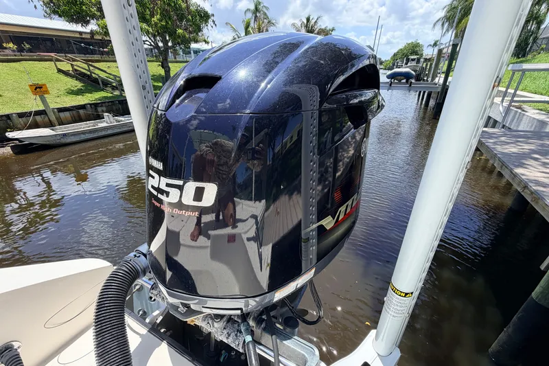 Slide: The Image of Yamaha 250 VMAX outboard motor on a 2015 Pathfinder 2300 HPS boat by a canal. - 9