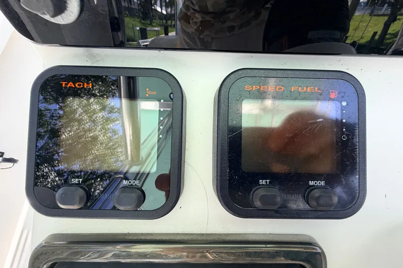 Slide: The Image of Dashboard of a 2013 Pathfinder 2300 HPS boat with tachometer and speed fuel gauges. - 42