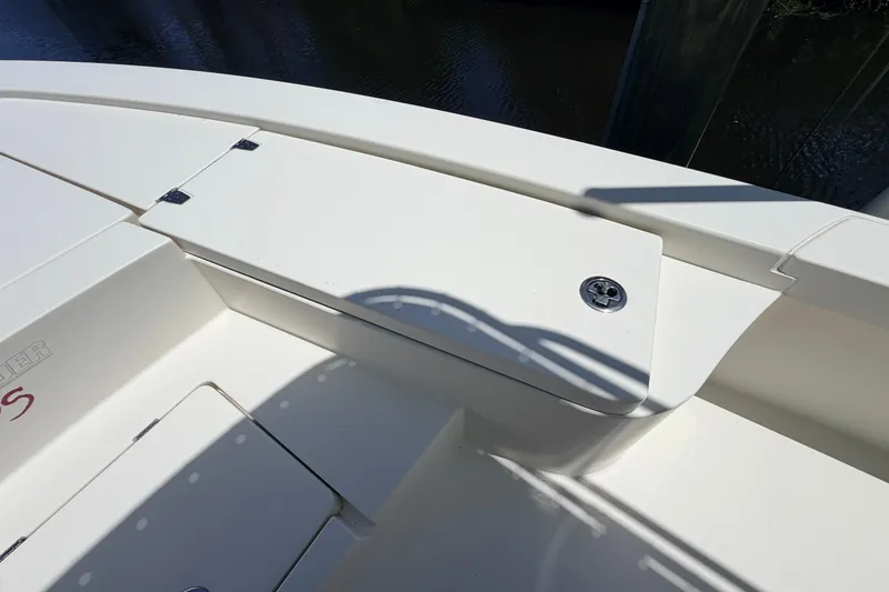 Slide: The Image of 2013 Pathfinder 2300 HPS boat deck with storage compartment and clean white finish. - 75