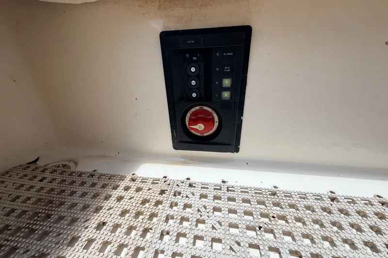 Slide: The Image of Control panel on 2015 Pathfinder 2300 HPS boat, featuring switches and a red dial. - 19
