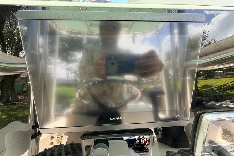 Slide: The Image of Reflection on Garmin screen aboard 2013 Pathfinder 2300 HPS boat. - 44