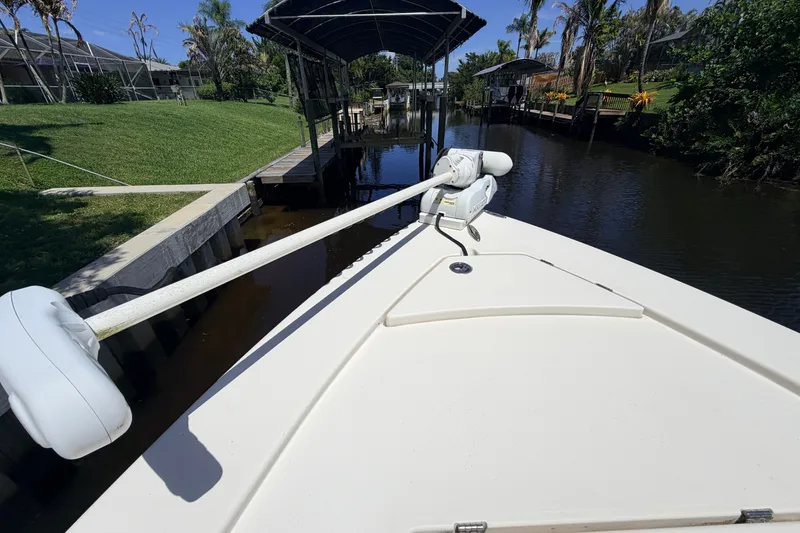 Slide: The Image of Bow view of a 2013 Pathfinder 2300 HPS boat docked in a canal. - 85