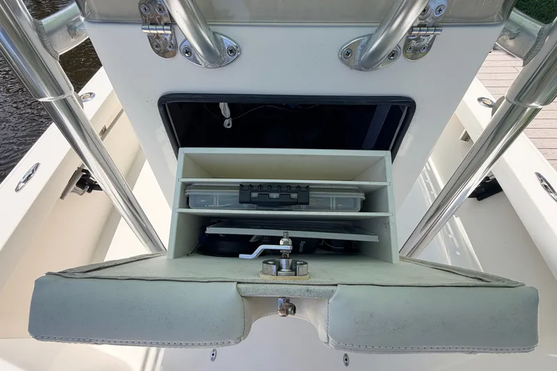 Slide: The Image of Storage compartment on a 2013 Pathfinder 2300 HPS boat, featuring organized shelves and equipment. - 57