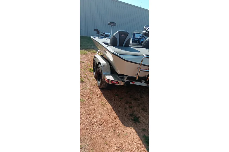 Slide: The Image of 2025 Ranger ALPHA 208 boat on trailer, parked outdoors near a building. - 4