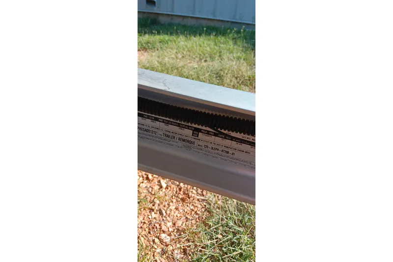 Slide: The Image of Close-up of Ranger ALPHA 208 trailer label, 2025 model, outdoors on grass. - 21