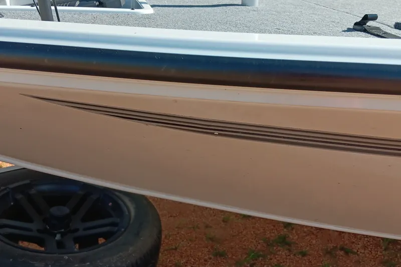 Slide: The Image of Side view of 2025 Ranger ALPHA 208 boat with sleek design and black wheel. - 17