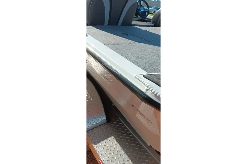 Slide: The Image of 2025 Ranger ALPHA 208 boat interior with carpeted deck and steering wheel visible. - 6
