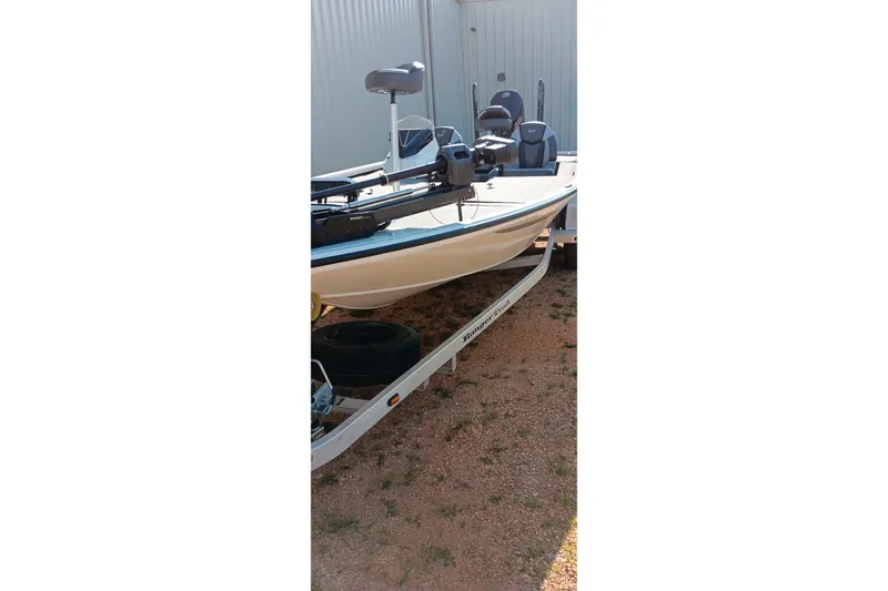 Slide: The Image of 2025 Ranger ALPHA 208 boat on trailer, parked outdoors, side view. - 19