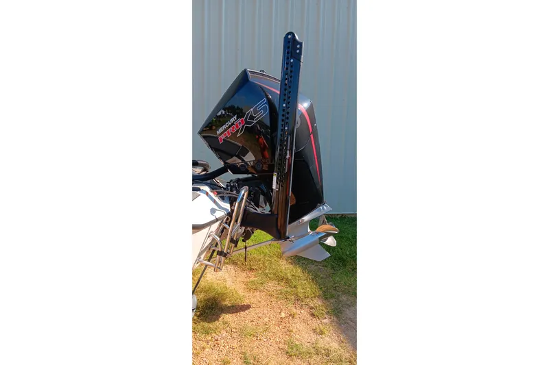 Slide: The Image of Ranger ALPHA 208 (2025) with Mercury Pro XS outboard motor, parked outdoors. - 14