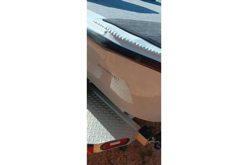 Slide: The Image of Close-up of a 2025 Ranger ALPHA 208 boat on a trailer, showing hull detail. - 5