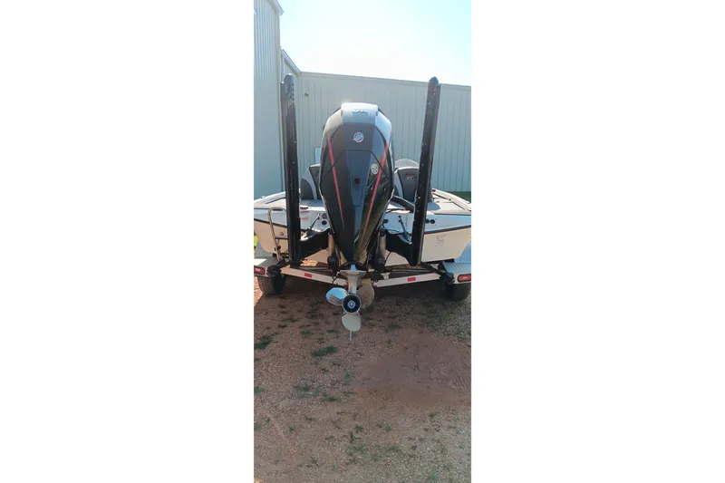 Slide: The Image of 2025 Ranger ALPHA 208 boat on trailer, rear view with motor and propeller visible. - 3
