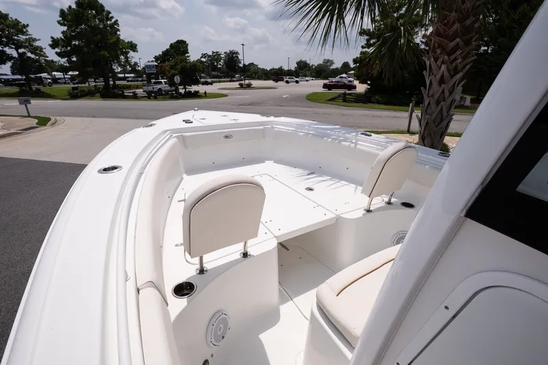 Slide: The Image of 2022 Sea Hunt Ultra 265SE boat interior with seating and deck view. - 11