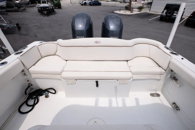 Slide: The Image of 2022 Sea Hunt Ultra 265SE boat with spacious white seating and dual engines. - 15
