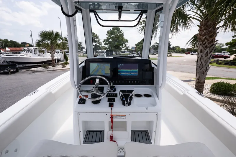 Slide: The Image of 2022 Sea Hunt Ultra 265SE boat dashboard with navigation display and steering wheel. - 8