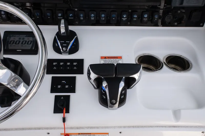 Slide: The Image of Control panel of 2022 Sea Hunt Ultra 265SE boat with steering wheel and throttle controls. - 17