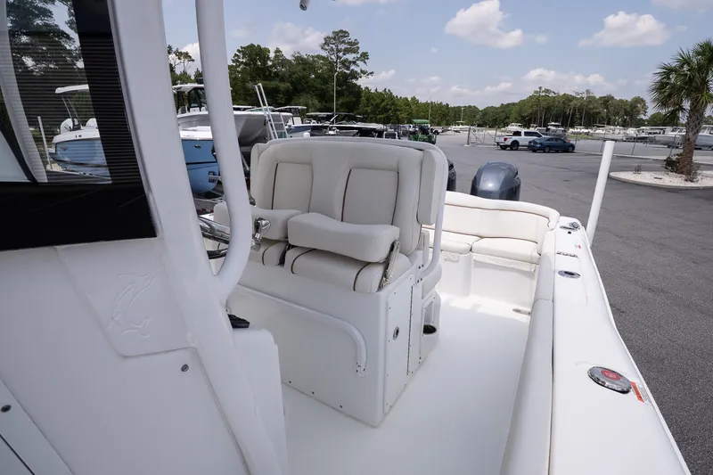 Slide: The Image of 2022 Sea Hunt Ultra 265SE boat interior with white seating and modern design. - 14