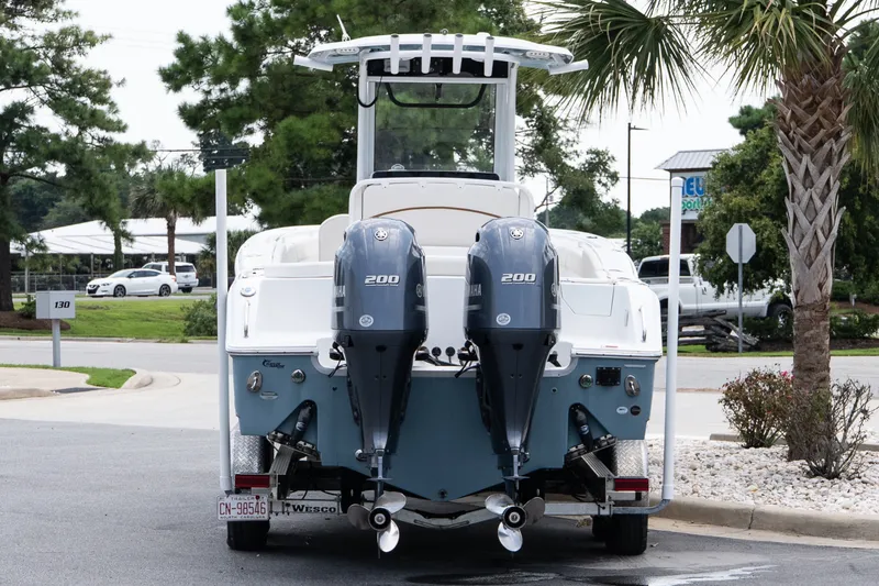 Slide: The Image of 2022 Sea Hunt Ultra 265SE boat with dual Yamaha 200 engines on a trailer. - 5