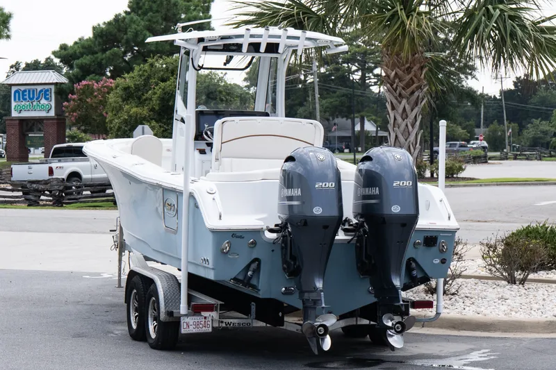 Slide: The Image of 2022 Sea Hunt Ultra 265SE boat with dual Yamaha engines on a trailer. - 4