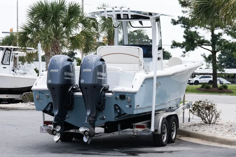 Slide: The Image of 2022 Sea Hunt Ultra 265SE boat with dual Yamaha 200 engines on a trailer. - 6