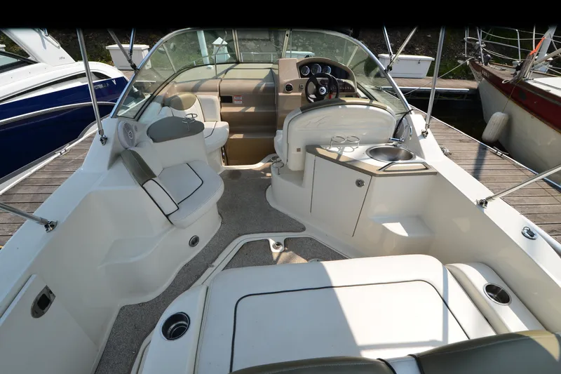 Slide: The Image of 2007 Sea Ray 240 Sundancer boat interior with seating, steering wheel, and sink. - 5