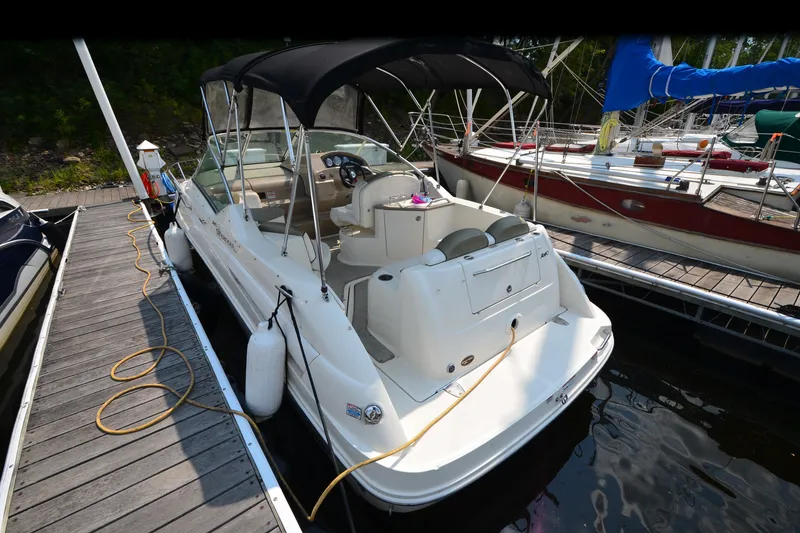 Slide: The Image of 2007 Sea Ray 240 Sundancer docked at marina with black canopy. - 3