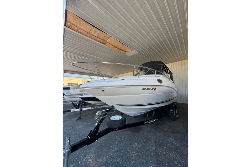 Slide: The Image of 2007 Sea Ray 240 Sundancer boat on trailer in covered storage area. - 22