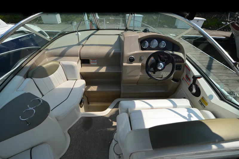 Slide: The Image of 2007 Sea Ray 240 Sundancer boat interior with steering wheel and seating area. - 10