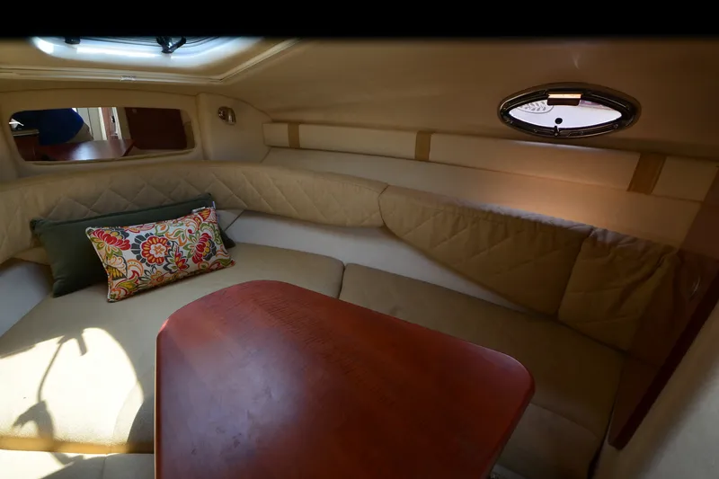 Slide: The Image of Interior cabin of 2007 Sea Ray 240 Sundancer with cozy seating and decorative pillows. - 13