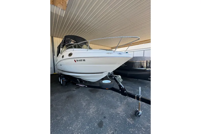 Slide: The Image of 2007 Sea Ray 240 Sundancer boat on trailer in covered storage area. - 23