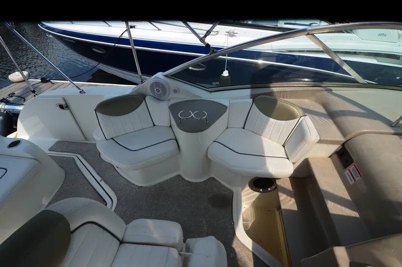 Slide: The Image of Interior of a 2007 Sea Ray 240 Sundancer boat with seating and cup holders. - 9