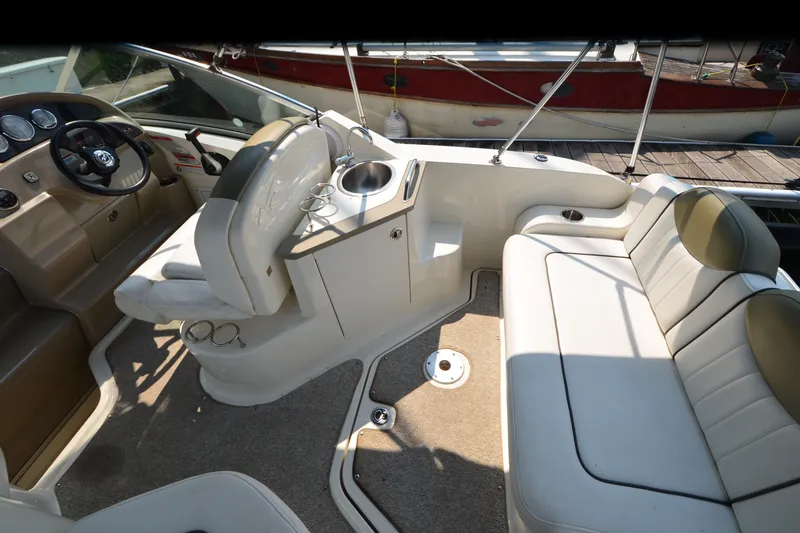 Slide: The Image of Interior of a 2007 Sea Ray 240 Sundancer boat with seating and helm. - 17