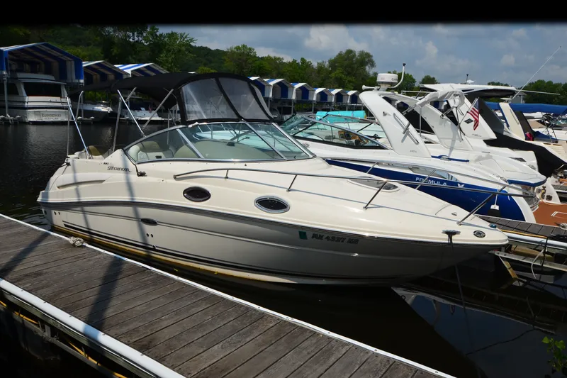Slide: The Image of 2007 Sea Ray 240 Sundancer docked at marina, surrounded by other boats. - 18