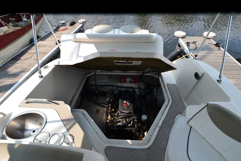 Slide: The Image of 2007 Sea Ray 240 Sundancer boat engine compartment open at dockside. - 16