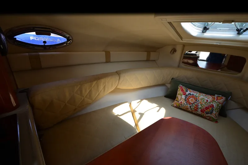 Slide: The Image of Interior cabin of 2007 Sea Ray 240 Sundancer with cozy seating and decorative pillow. - 12