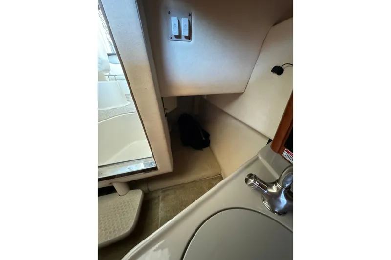 Slide: The Image of 2007 Sea Ray 240 Sundancer cabin interior with sink and storage area. - 24