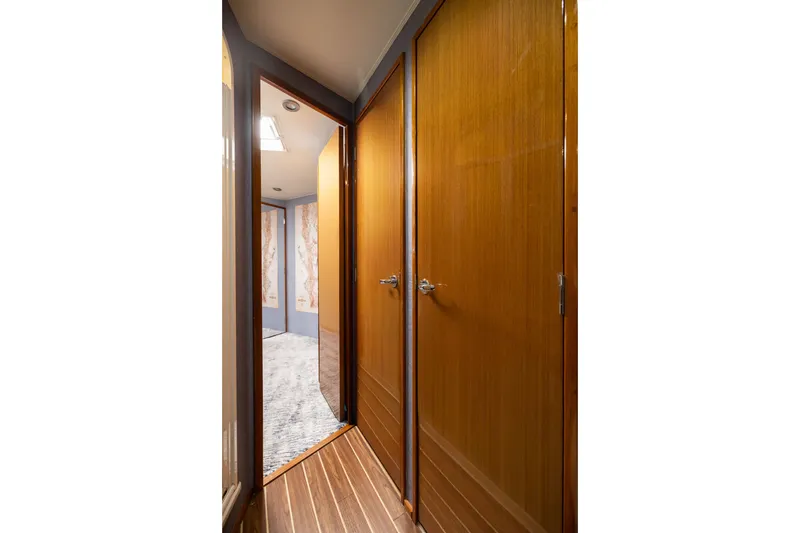 Slide: The Image of Hallway inside 2001 Viking 55 Convertible yacht with wooden doors and flooring. - 60