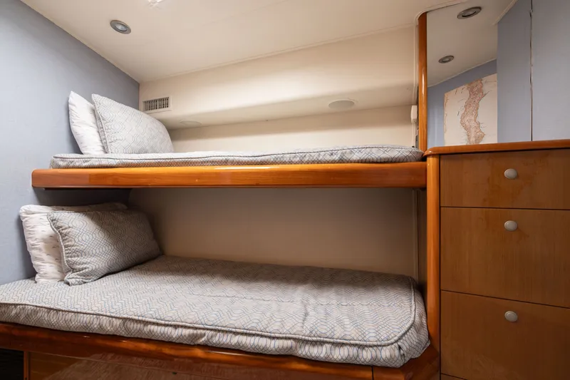 Slide: The Image of Bunk beds in 2001 Viking 55 Convertible yacht cabin with wooden cabinetry. - 54