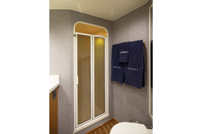 Slide: The Image of Bathroom interior of 2001 Viking 55 Convertible yacht with shower and navy towels. - 47
