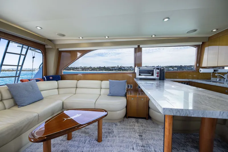 Slide: The Image of Luxurious interior of a 2001 Viking 55 Convertible yacht with plush seating and modern amenities. - 36