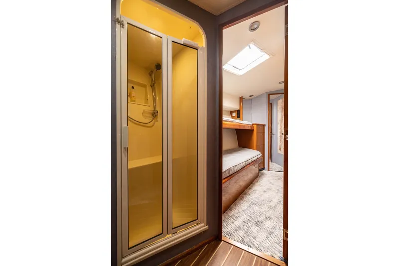 Slide: The Image of Interior of 2001 Viking 55 Convertible yacht showing shower and bunk beds. - 57