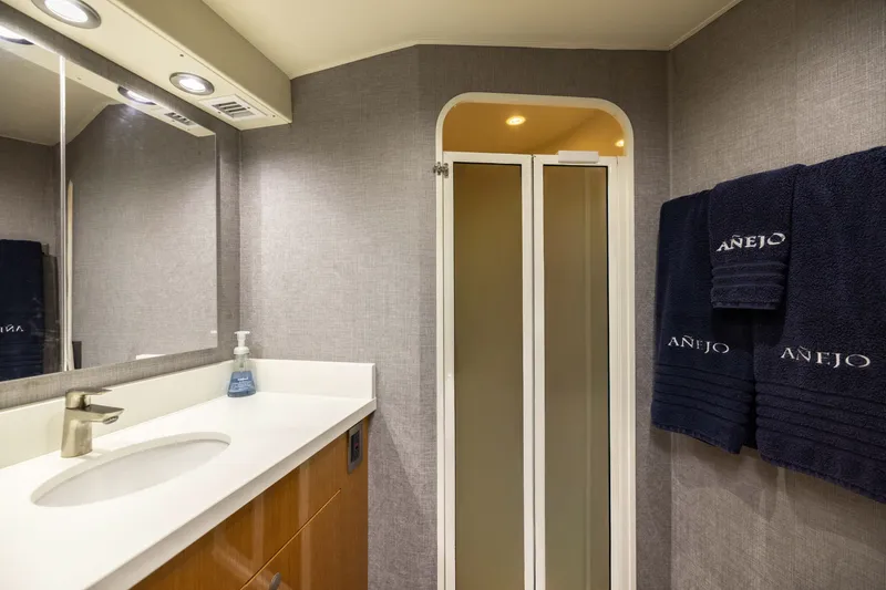 Slide: The Image of Luxurious bathroom in 2001 Viking 55 Convertible yacht with modern fixtures and plush towels. - 48
