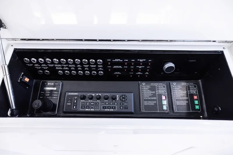 Slide: The Image of Control panel of a 2001 Viking 55 Convertible yacht with various switches and displays. - 20