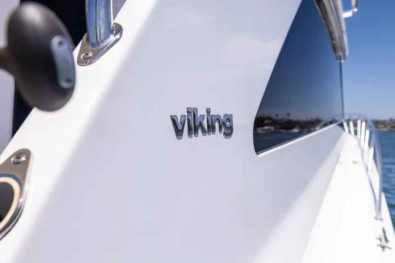 Slide: The Image of Side view of a 2001 Viking 55 Convertible yacht with logo. - 29