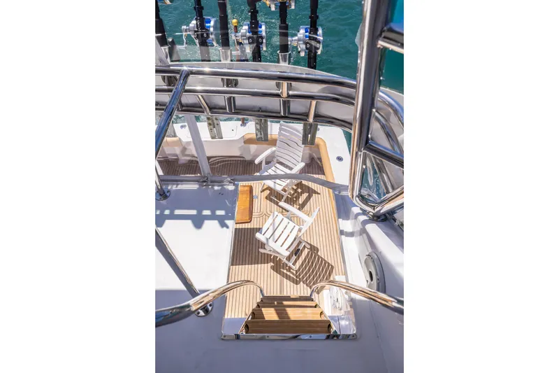 Slide: The Image of View from Viking 55 Convertible 2001 yacht, showcasing deck chairs and fishing rods. - 6