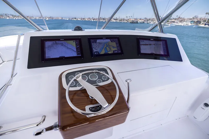 Slide: The Image of Helm of 2001 Viking 55 Convertible yacht with navigation screens and steering wheel. - 14