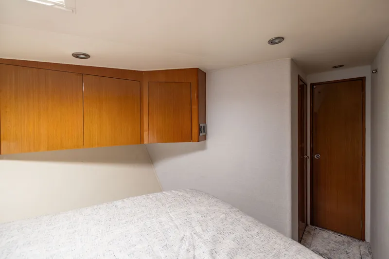 Slide: The Image of Interior cabin of 2001 Viking 55 Convertible yacht with wooden cabinets and door. - 52