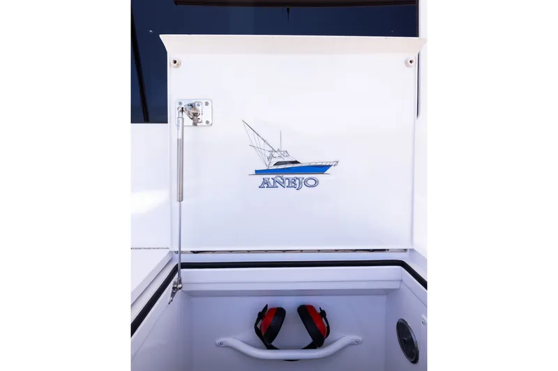 Slide: The Image of 2001 Viking 55 Convertible boat hatch with "ANEJO" logo and fishing rod graphic. - 21